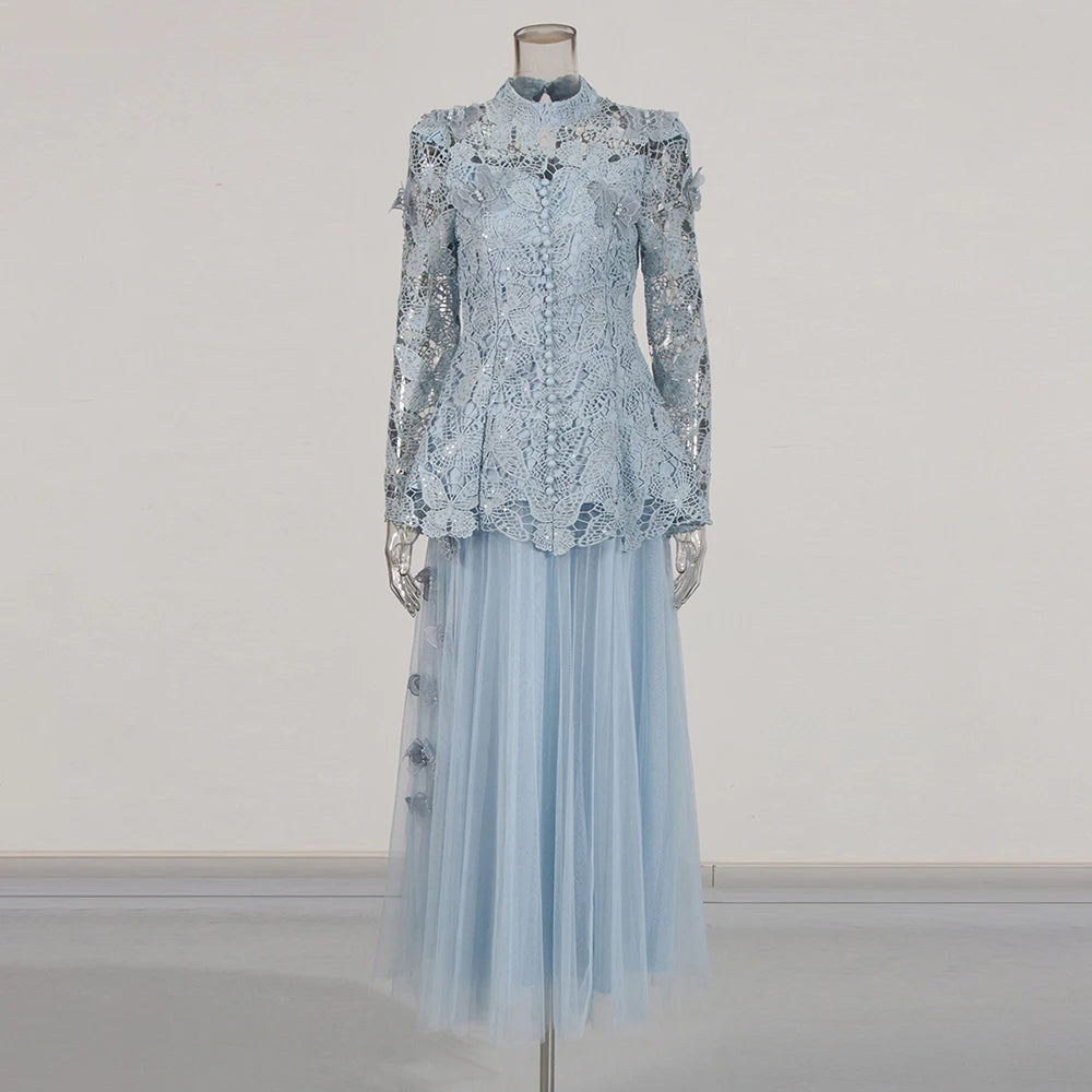 Light blue lace top and tulle skirt on a mannequin against a plain background
