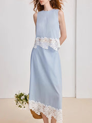 Light blue dress with white lace details on a plain background