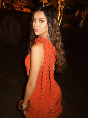 Draped red party dress with gathered folds and twist trim