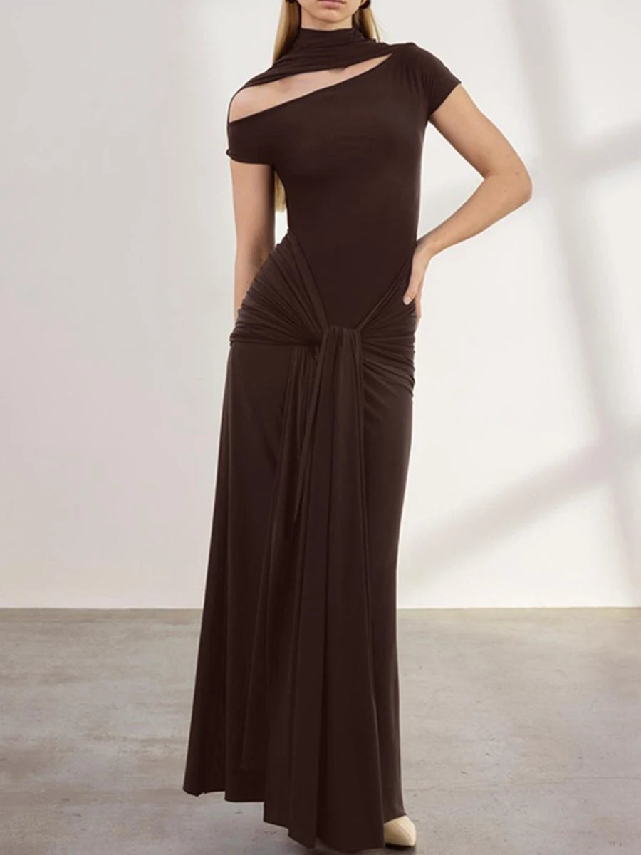 Woman wearing a brown evening gown against a plain background