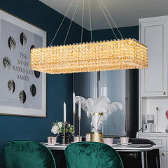 A stunning champagne crystal bead chandelier illuminating a modern dining room.  Golden Atelier 2