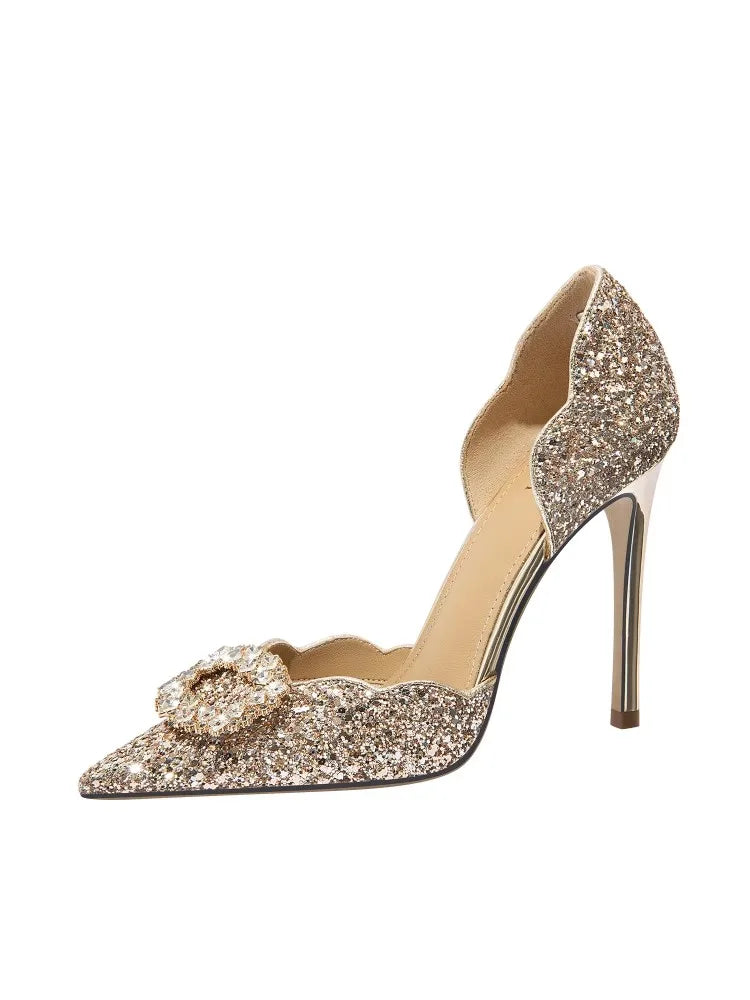 Sparkly high-heeled shoe with a decorative bow on a white background