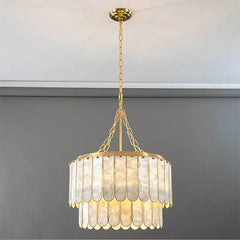 French vintage shell chandelier with gold chain and glass shades suspended in elegant interior