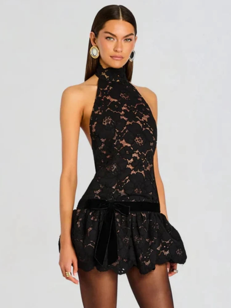 Back view of the black lace halter neck mini dress.