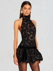 Back view of the black lace halter neck mini dress.