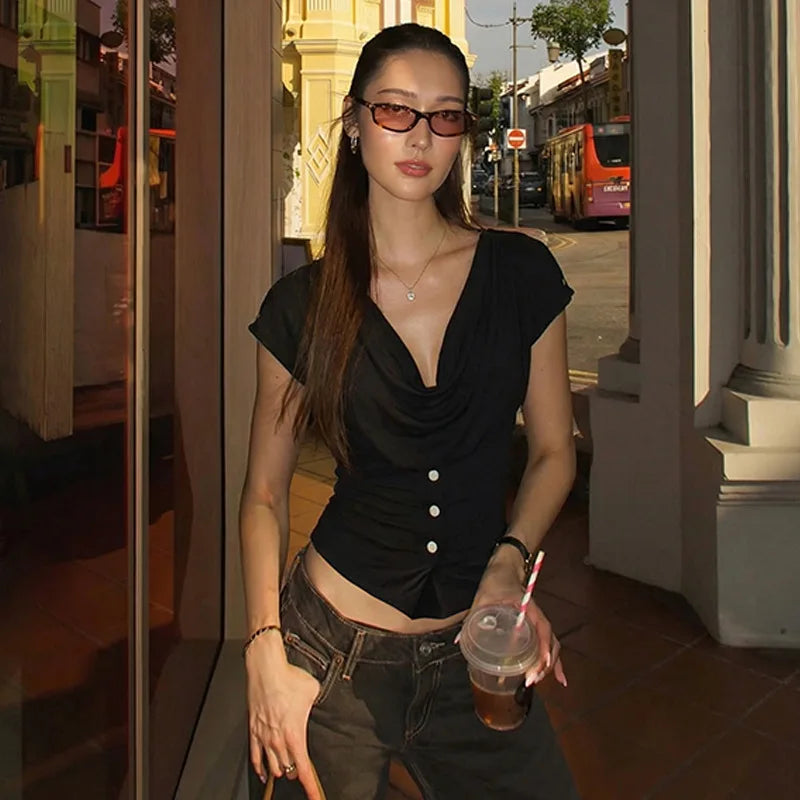 Woman holding a drink in an urban setting