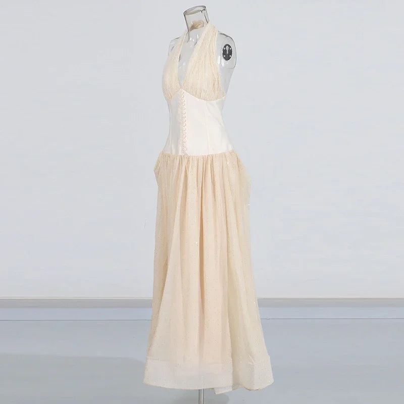 Beige dress on a mannequin against a plain background