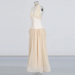 Beige dress on a mannequin against a plain background