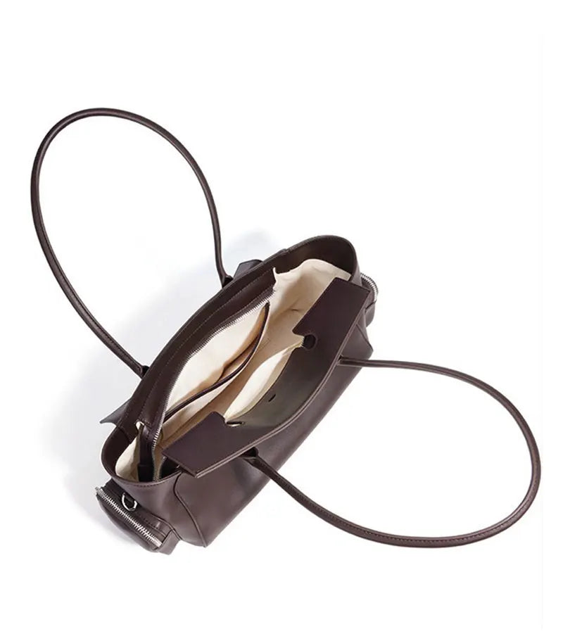 Brown handbag with a strap on a white background