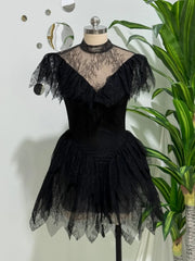 Black lace mini dress on mannequin with plant backdrop