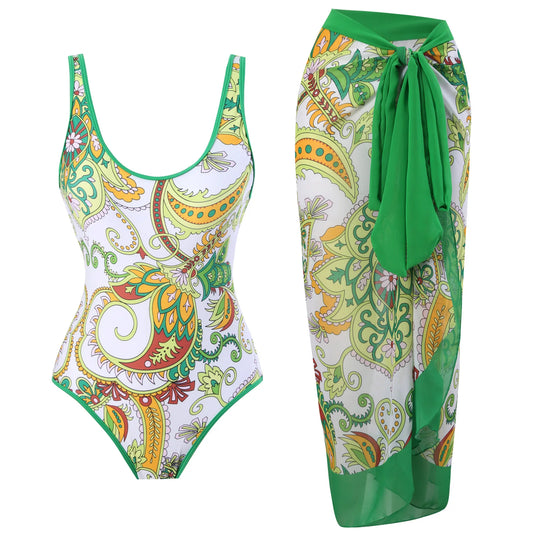 White and multicolor paisley print one-piece swimsuit with a matching wrap skirt.