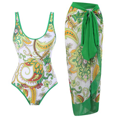 White and multicolor paisley print one-piece swimsuit with a matching wrap skirt.