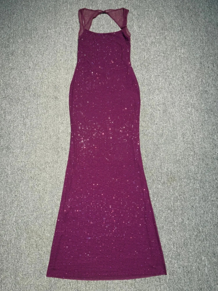Purple evening gown on a textured gray surface
