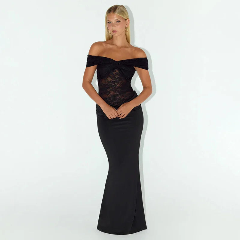 Woman wearing a black off-shoulder dress against a white background