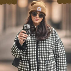 A woman wearing a black, white, and gray plaid quilted jacket with a stand neck, showcasing its stylish design  Golden Atelier 4