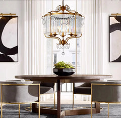 Modern crystal chandelier with LED lights, hanging in a stylish living room. Golden Atelier 3