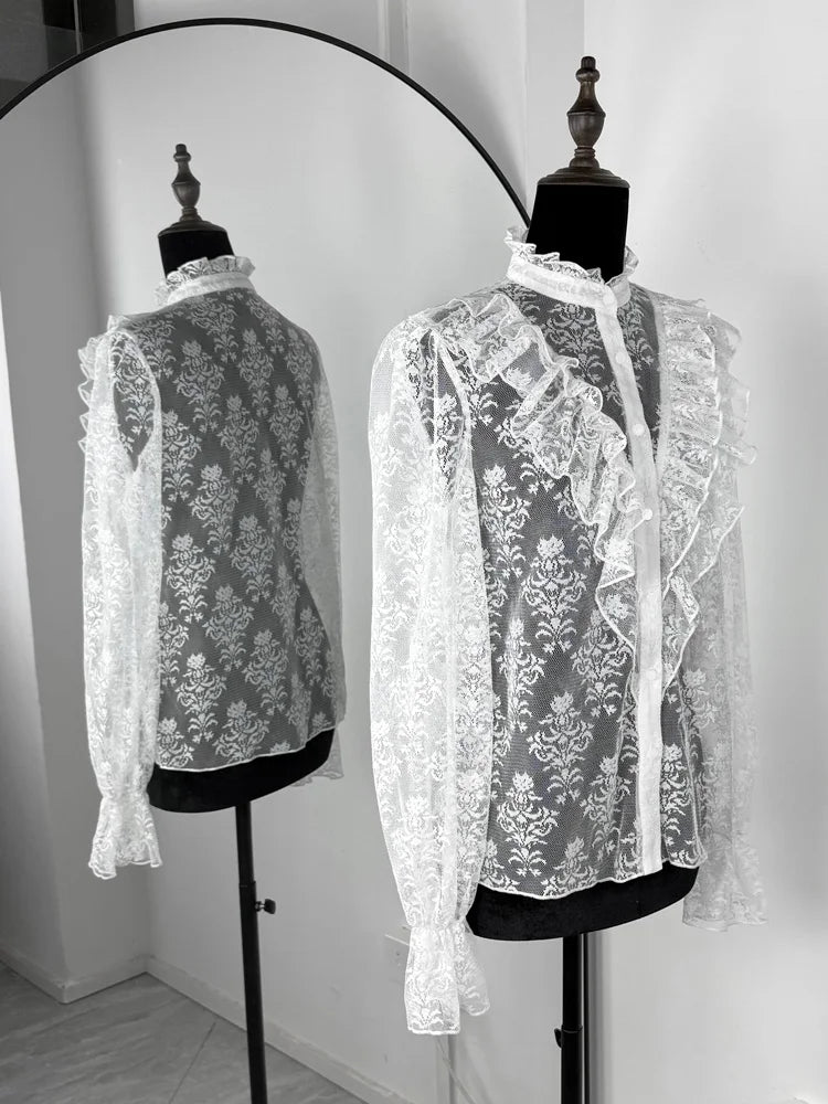 White lace blouse on a mannequin with a plain background