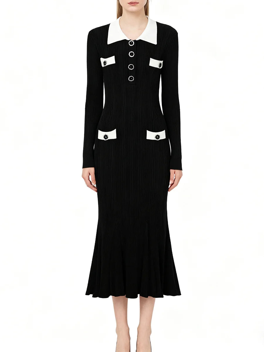 Black dress with white collar and buttons on a white background
