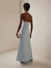 Woman wearing a strapless light blue gown against a plain background