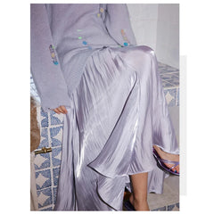 Person wearing a light purple outfit with a sheer overlay in a bathroom setting.