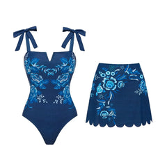 Blue floral patterned two-piece swimwear set including a one-piece swimsuit and a skirt.