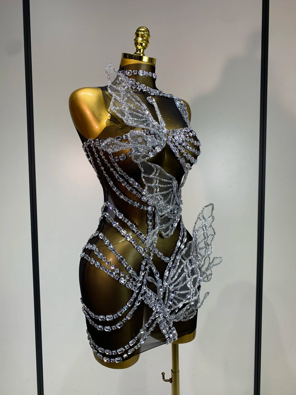 Side view of crystal butterfly mini dress with sheer mesh