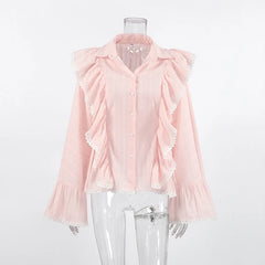 Pink blouse with ruffled details on a mannequin against a white background