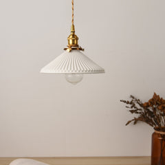 White ceramic pendant LED ceiling lights with iron finishes and gold plated details, suspended from the ceiling by visible wires and  artificial plant.