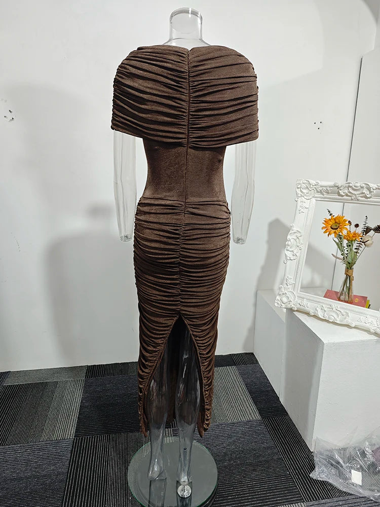 Brown pleated dress on a mannequin against a white wall.