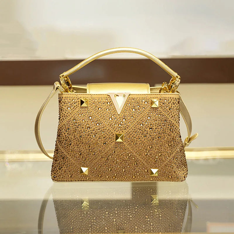 Close-up of a luxurious rhinestone crossbody handbag with rivet details and a top handle Golden Atelier  Gold 1