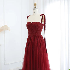 Mannequin displaying the wine-red beaded evening gown, showcasing its flattering silhouette and elegant design. Golden Atelier 3