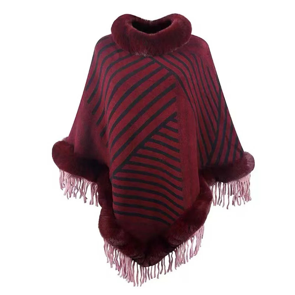 Red poncho with black stripes and fringes on a white background