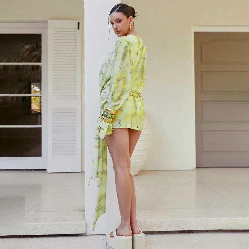 Woman in a yellow outfit standing on a porch