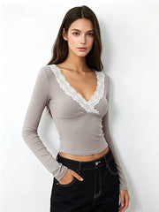 Woman wearing a grey lace trim v-neck long sleeve crop top