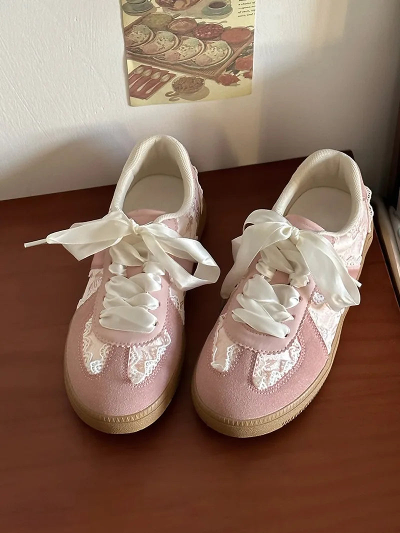 Pink lace-up ballet flats with ribbon ties