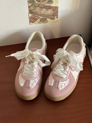 Pink lace-up ballet flats with ribbon ties