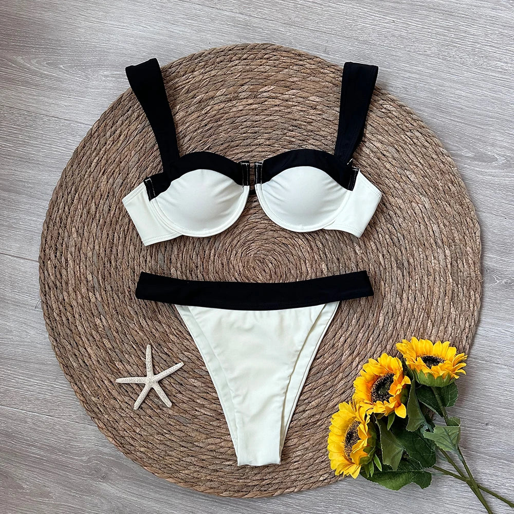 Flat lay of a contrast trim bikini set with decorative elements.
