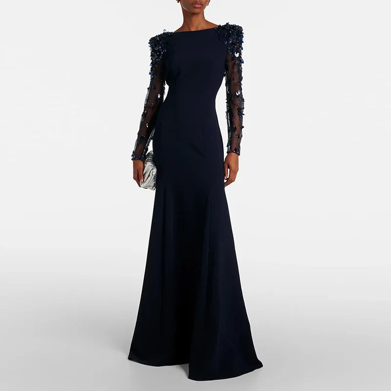 Black evening gown with sheer sleeves on a white background
