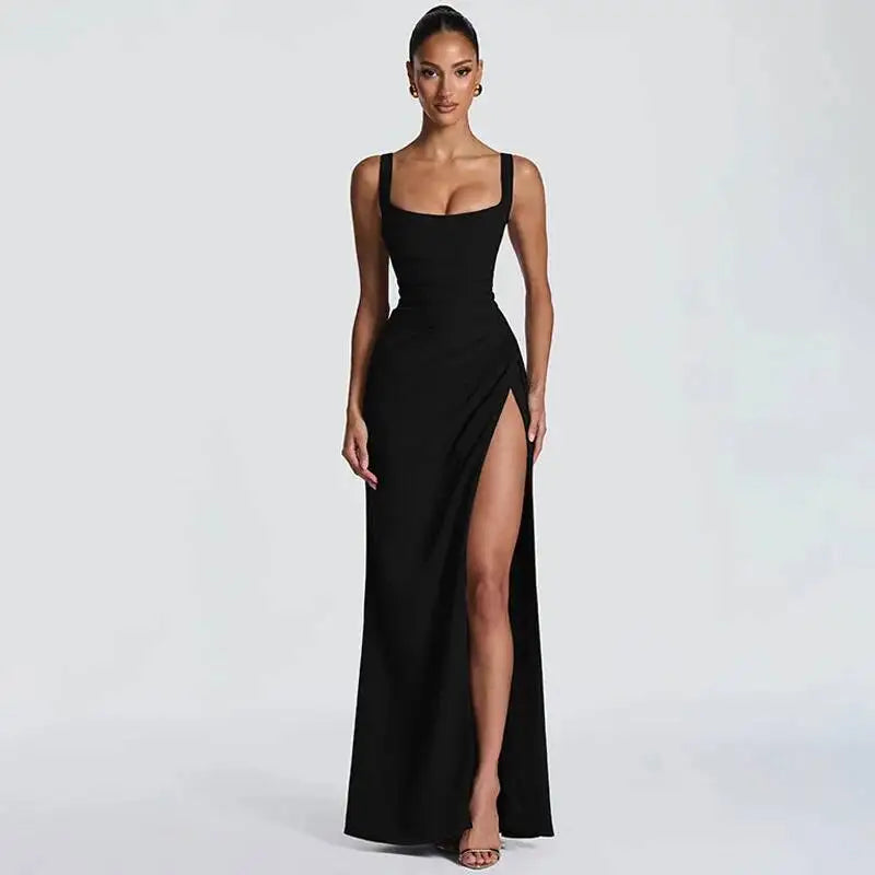Woman wearing a black evening gown with a high slit on a white background