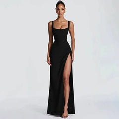 Woman wearing a black evening gown with a high slit on a white background