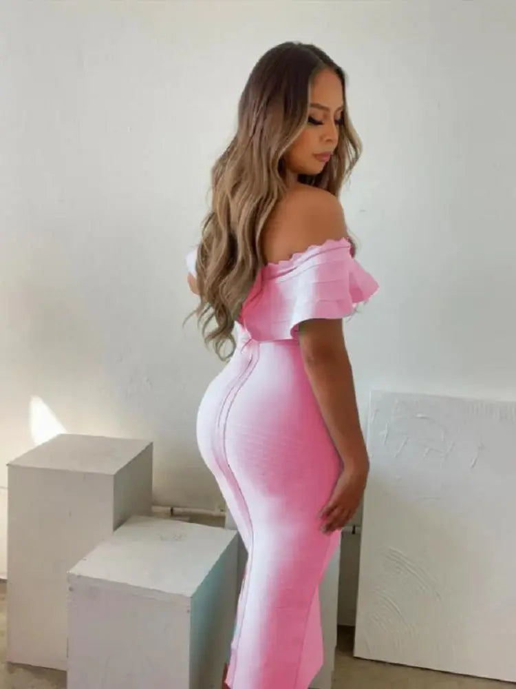 Woman wearing a pink off-shoulder dress in a minimal indoor setting