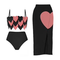 Black one-piece swimsuit with pink heart accents and a black beach skirt with a pink heart detail.