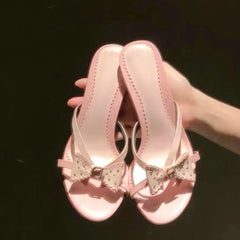 Close-up of pink bow accent heeled slides