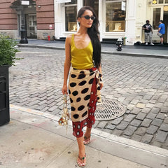 Full view of a woman wearing a printed wrap midi skirt