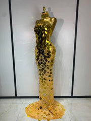 Gold sequin evening gown on a mannequin against a white background