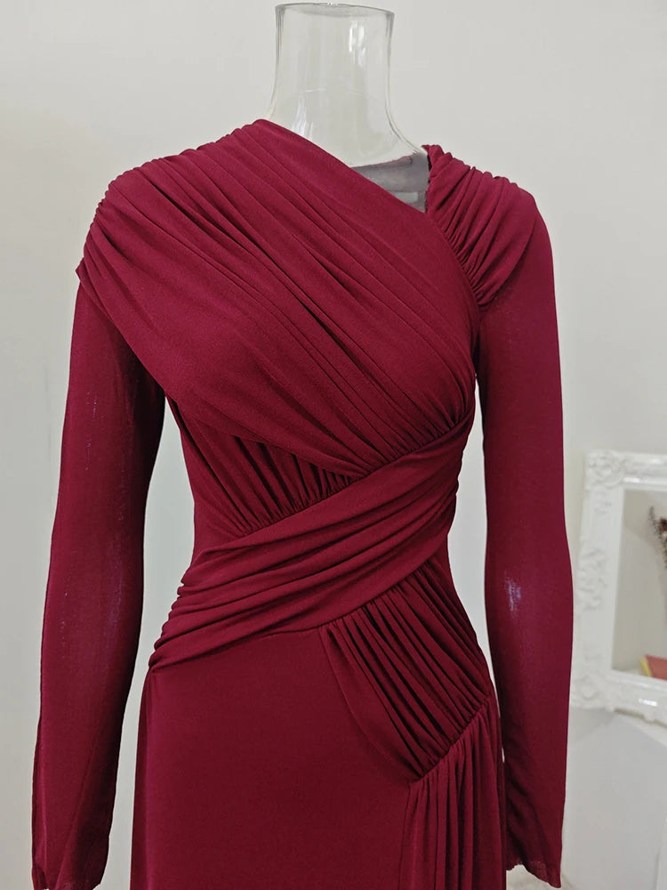 Red dress on a mannequin against a plain background