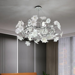 A modern floral chandelier with a chrome finish, illuminating a stylish living room. Golden Atelier 2