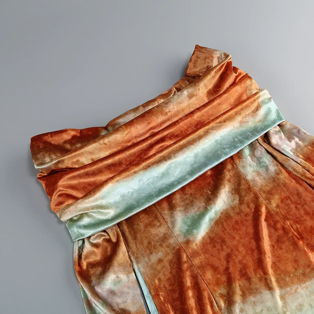 Folded fabric with orange and green gradient on a gray background