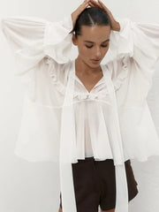 Side view of the lightweight white blouse in motion