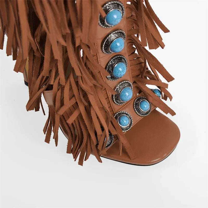 Fringed turquoise studded knee-high boots, back view showing zipper and heel